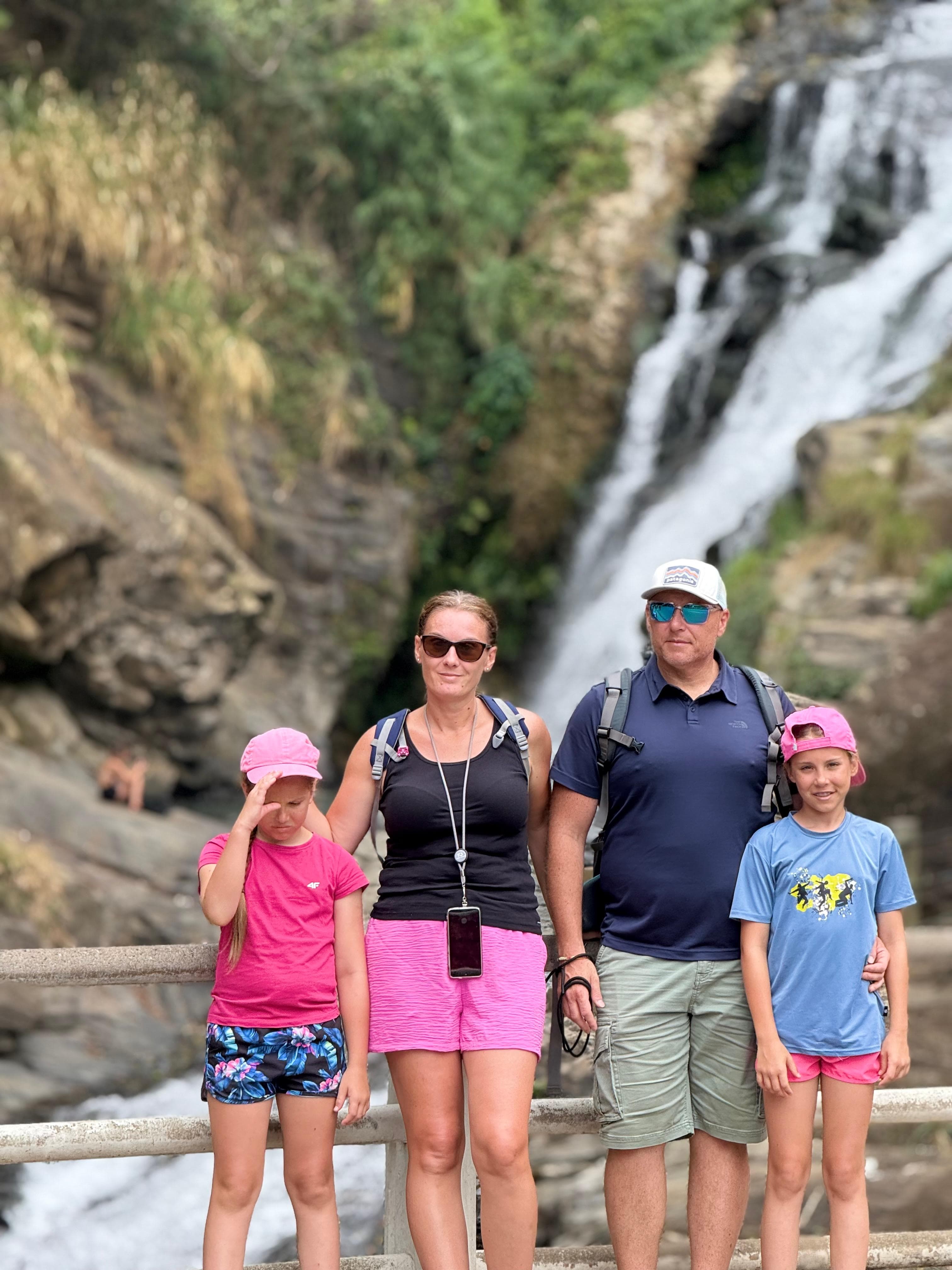 Family hiking to a waterfall