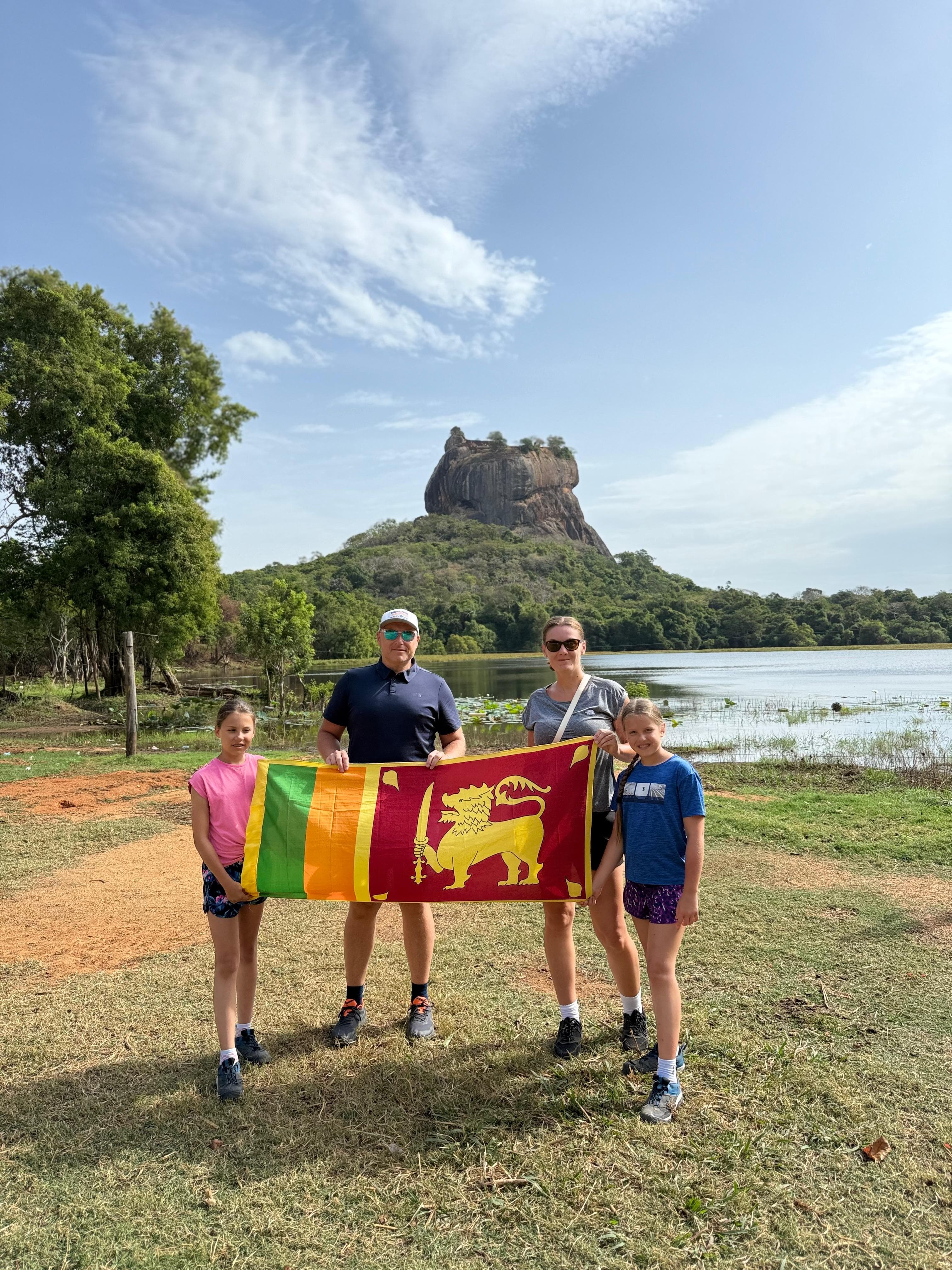 Family with the flag beside the Sigiriya lake