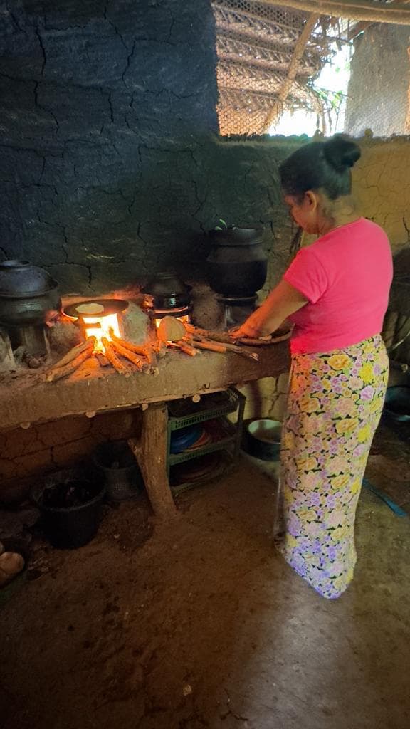 Woman cooking on a traditional stove