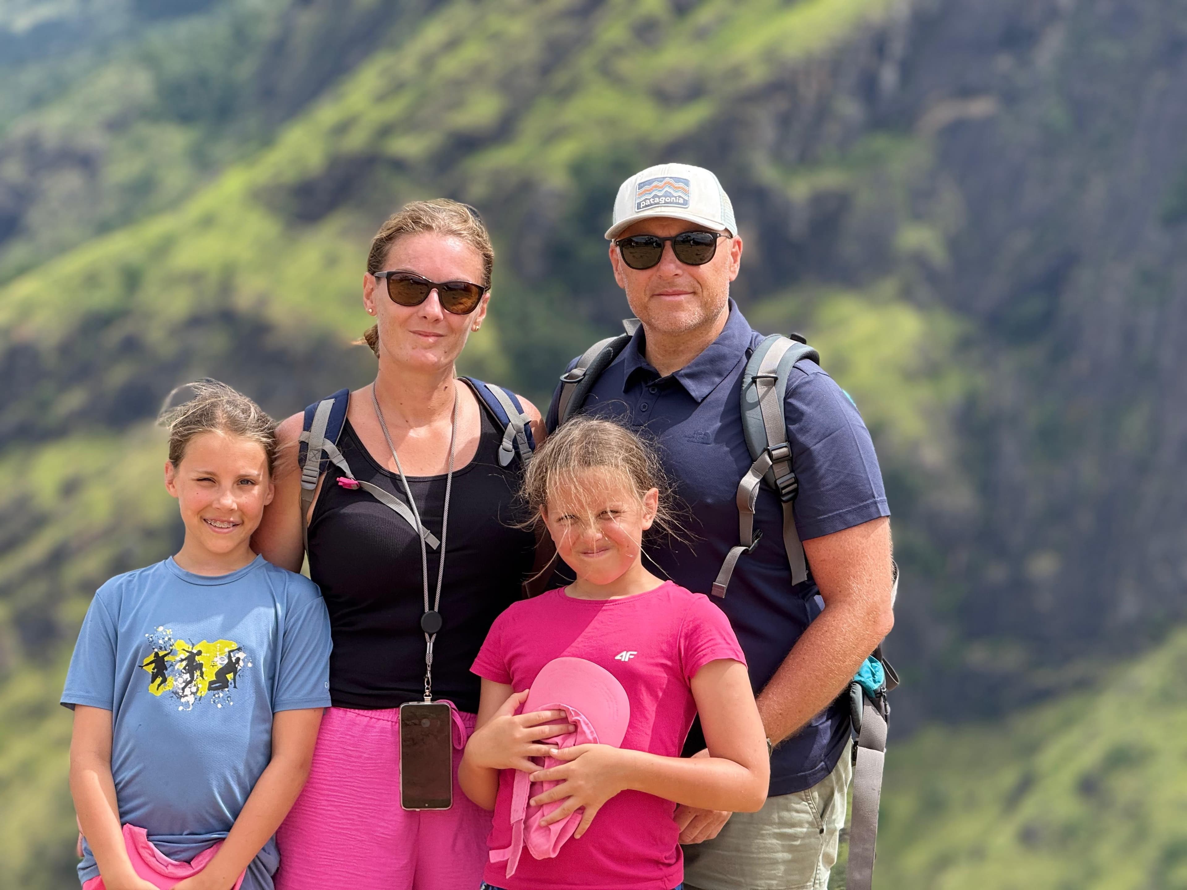 Family at a mountain cliff viewpoint