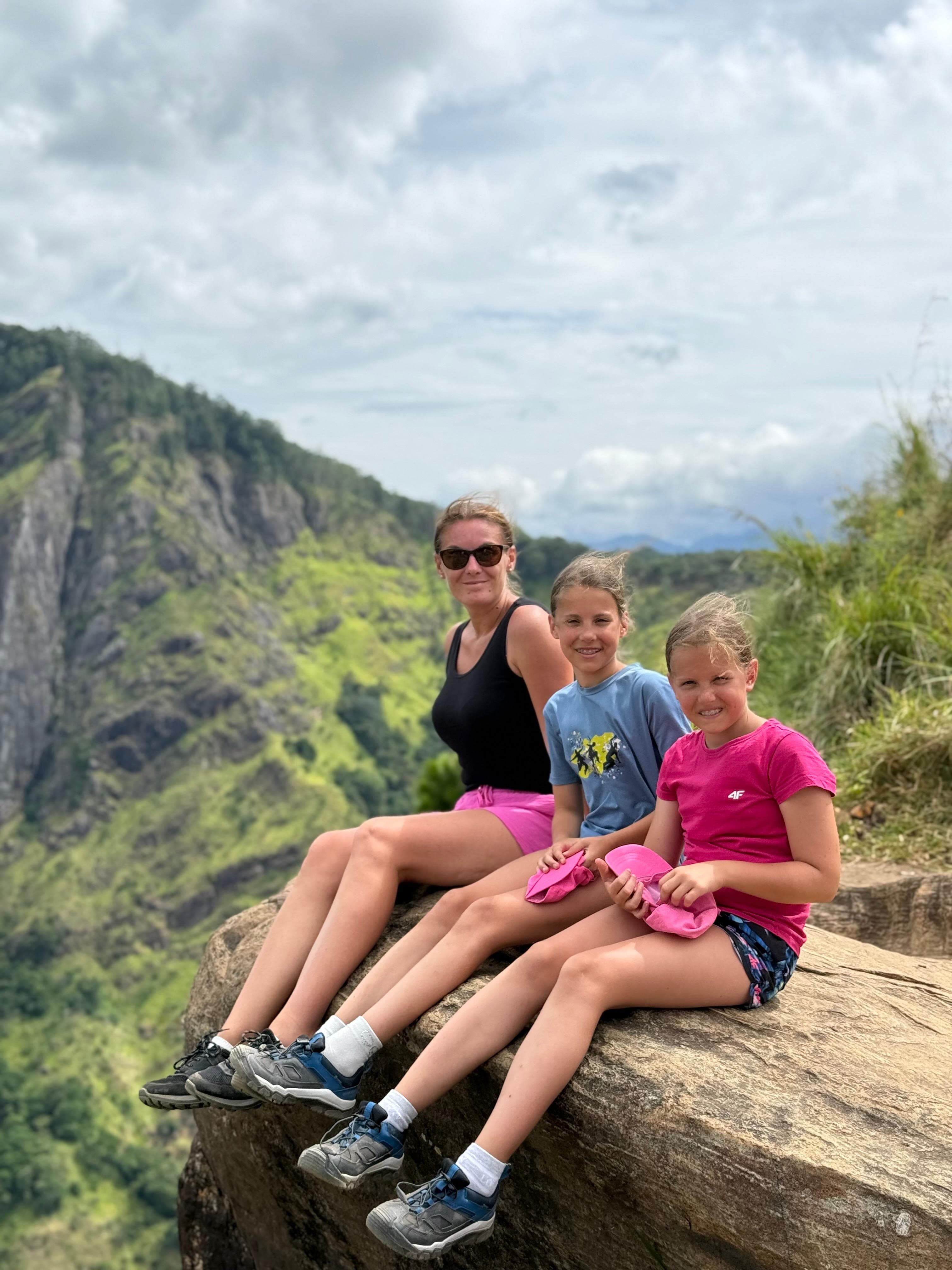 Mother and daughters at a cliff viewpoint