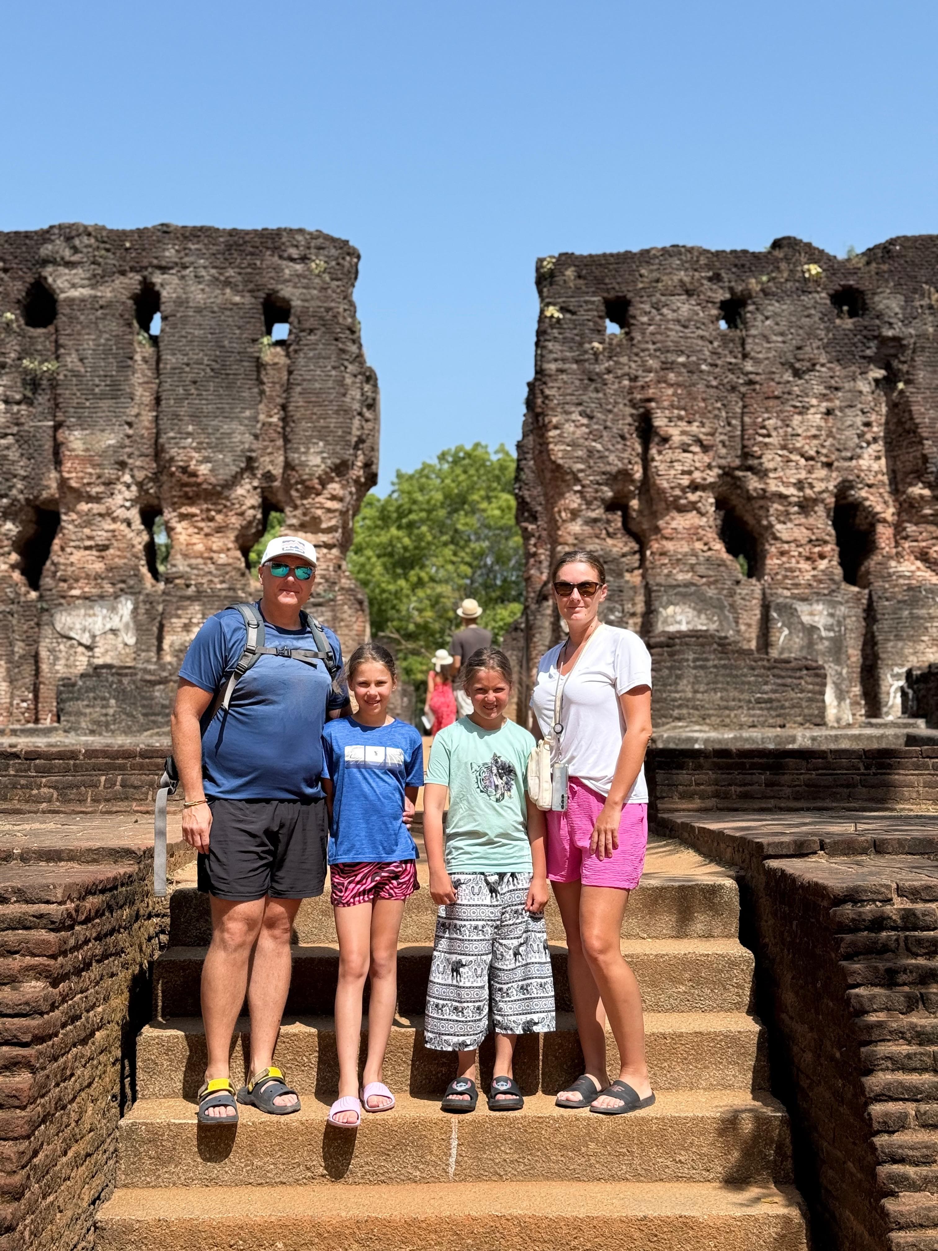 Family group on the steps of ancient ruins