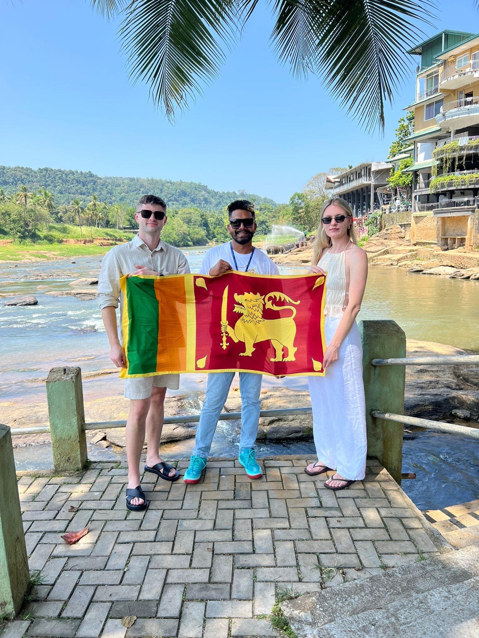 Group with the Sri Lanka flag by the river