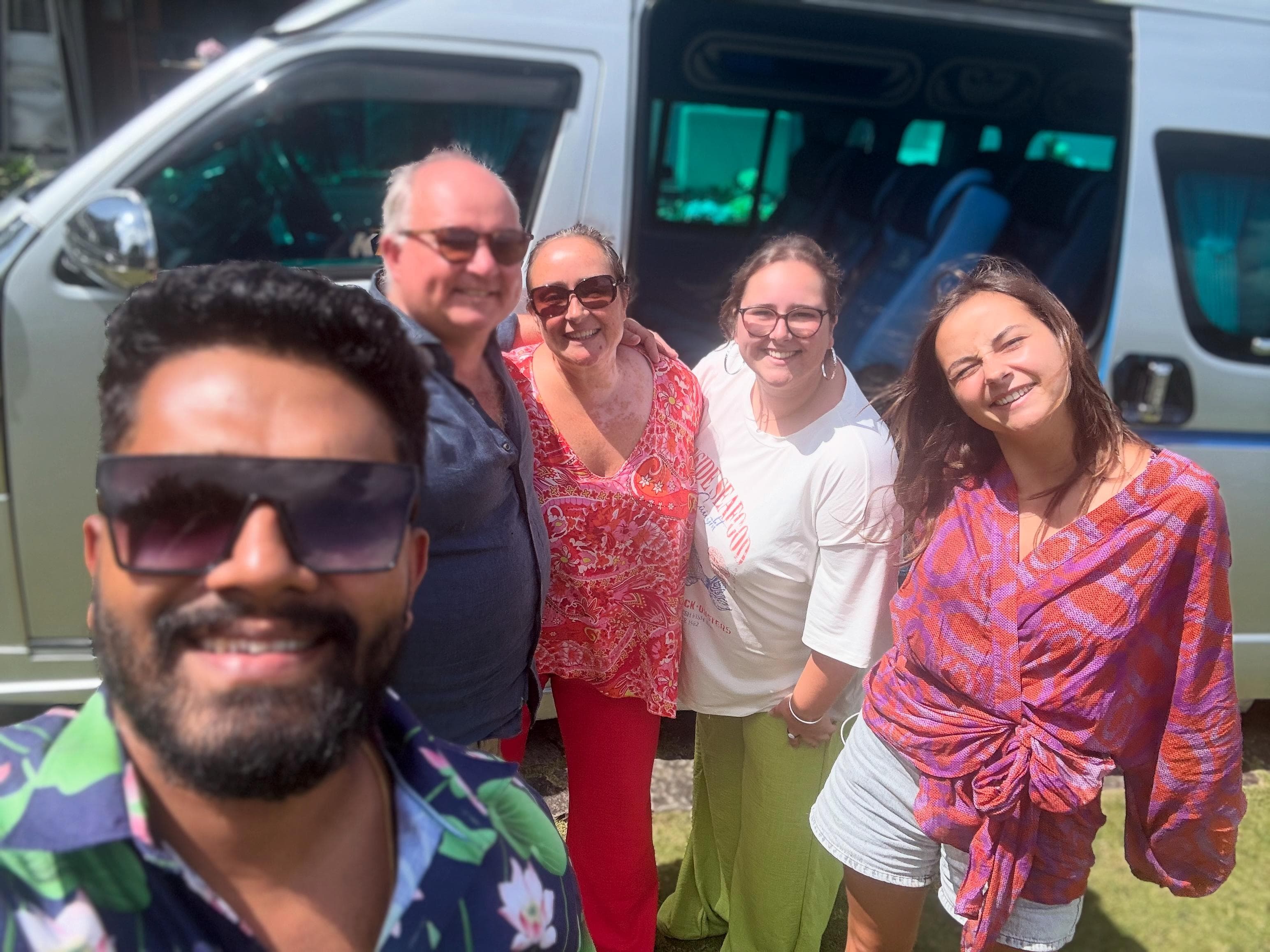 Group of friends portrait beside the tour van