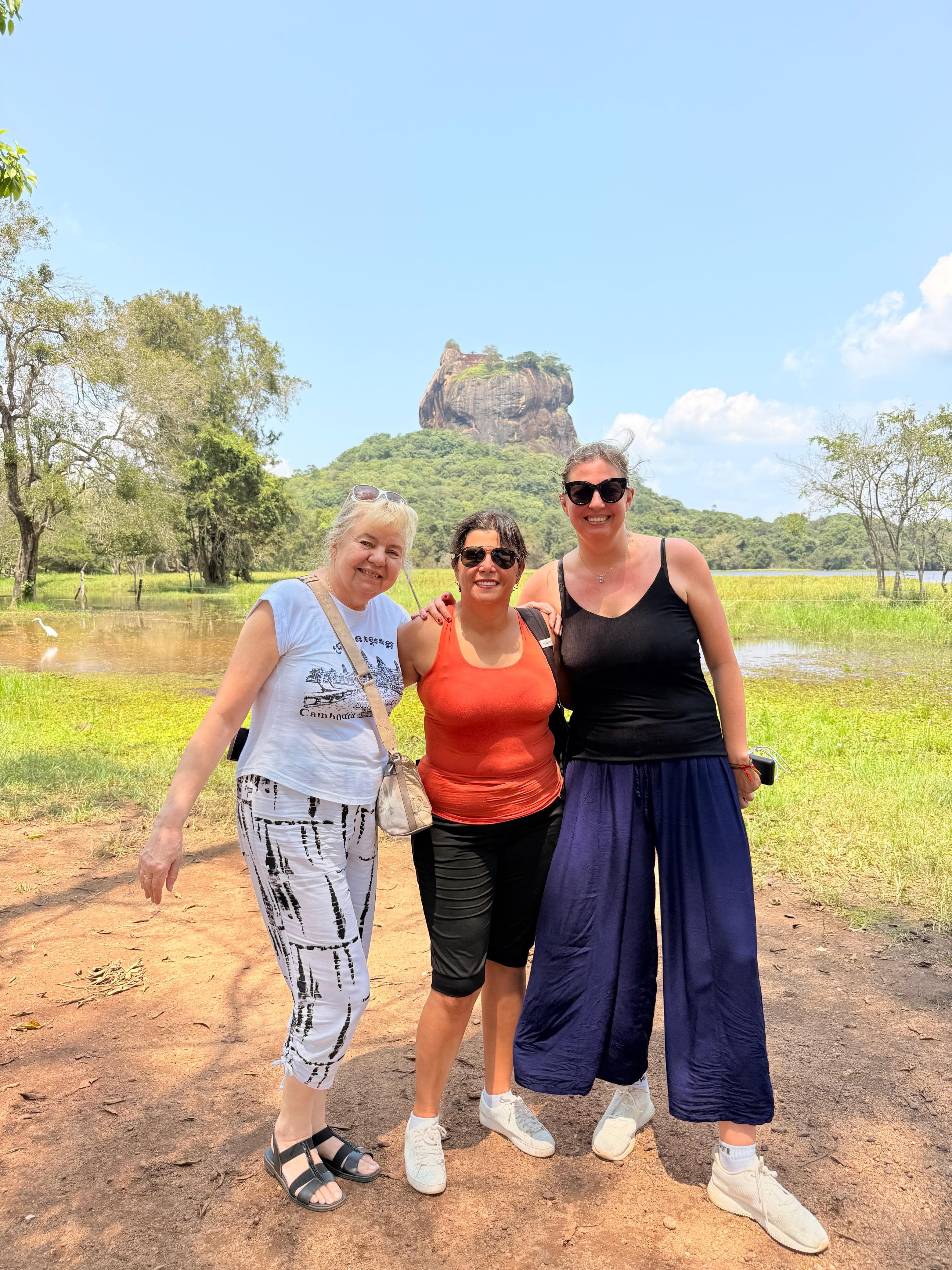 Women taking a selfie by the Sigiriya rock lake