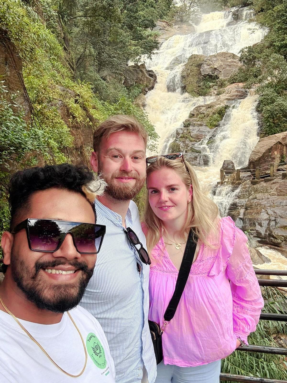 Guide and couple at a large waterfall