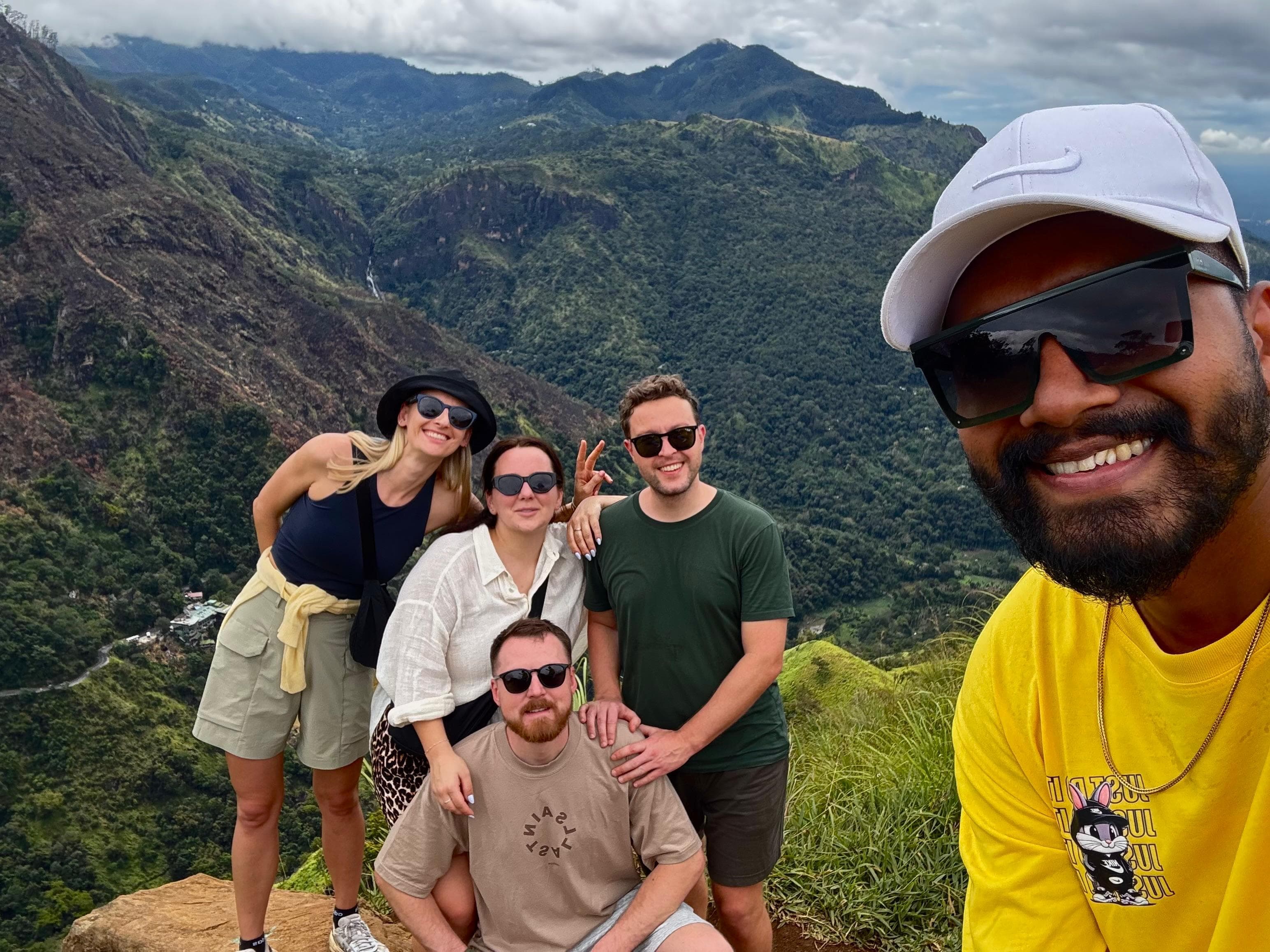 Guide with a group of friends at a mountain valley viewpoint