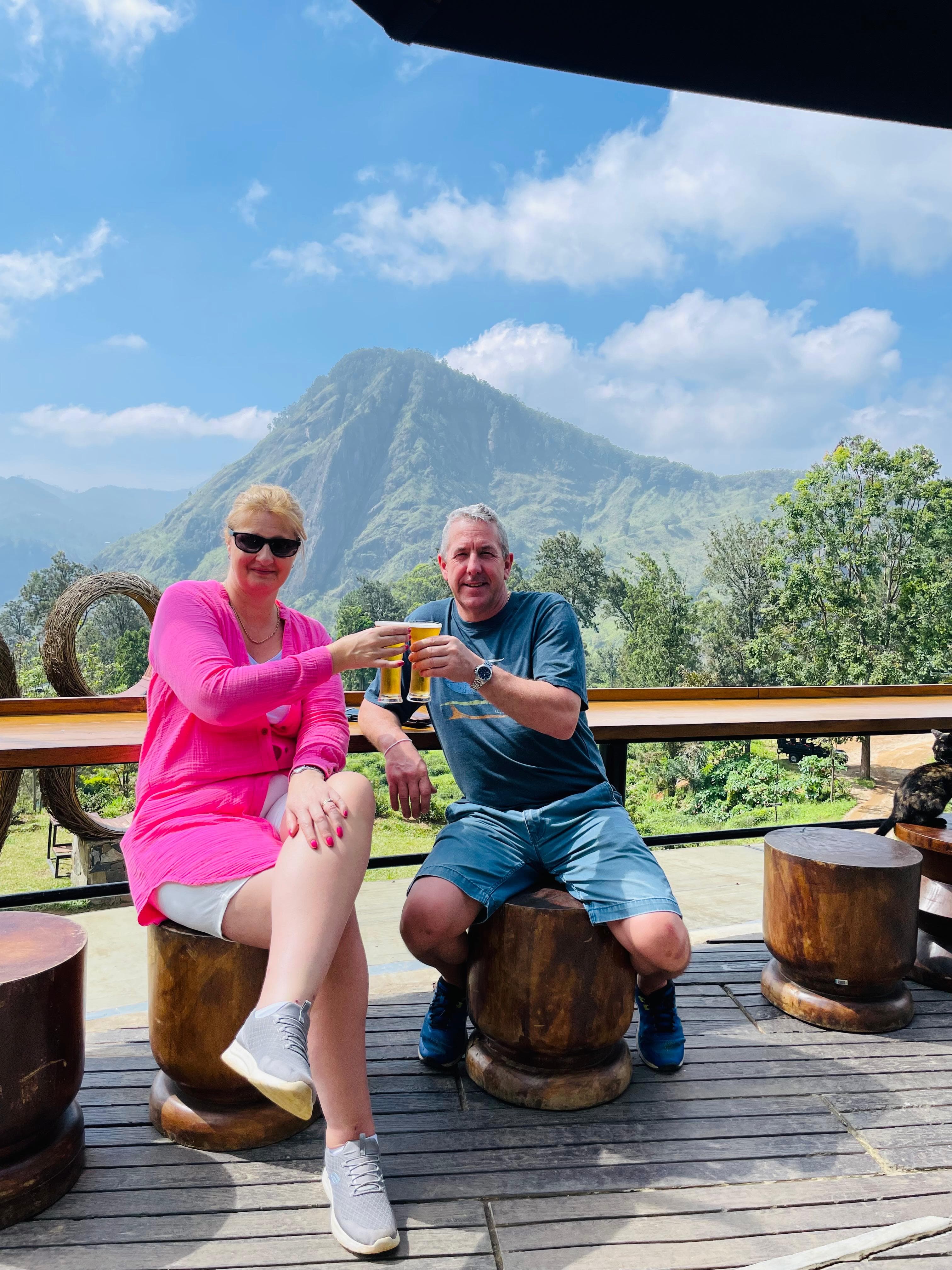 Couple toasting on a terrace with a mountain peak view