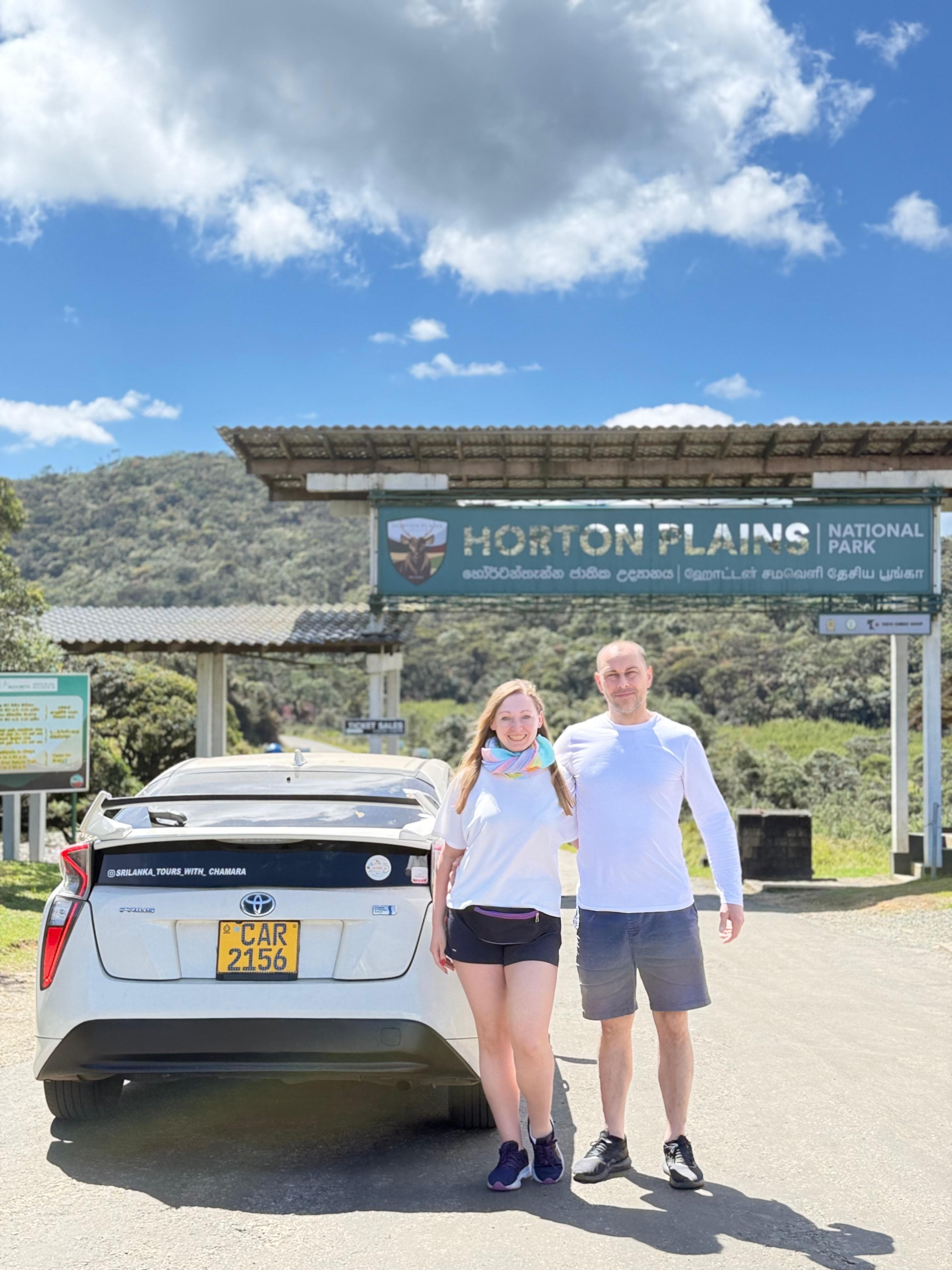 Couple at the sunny Horton Plains entrance sign