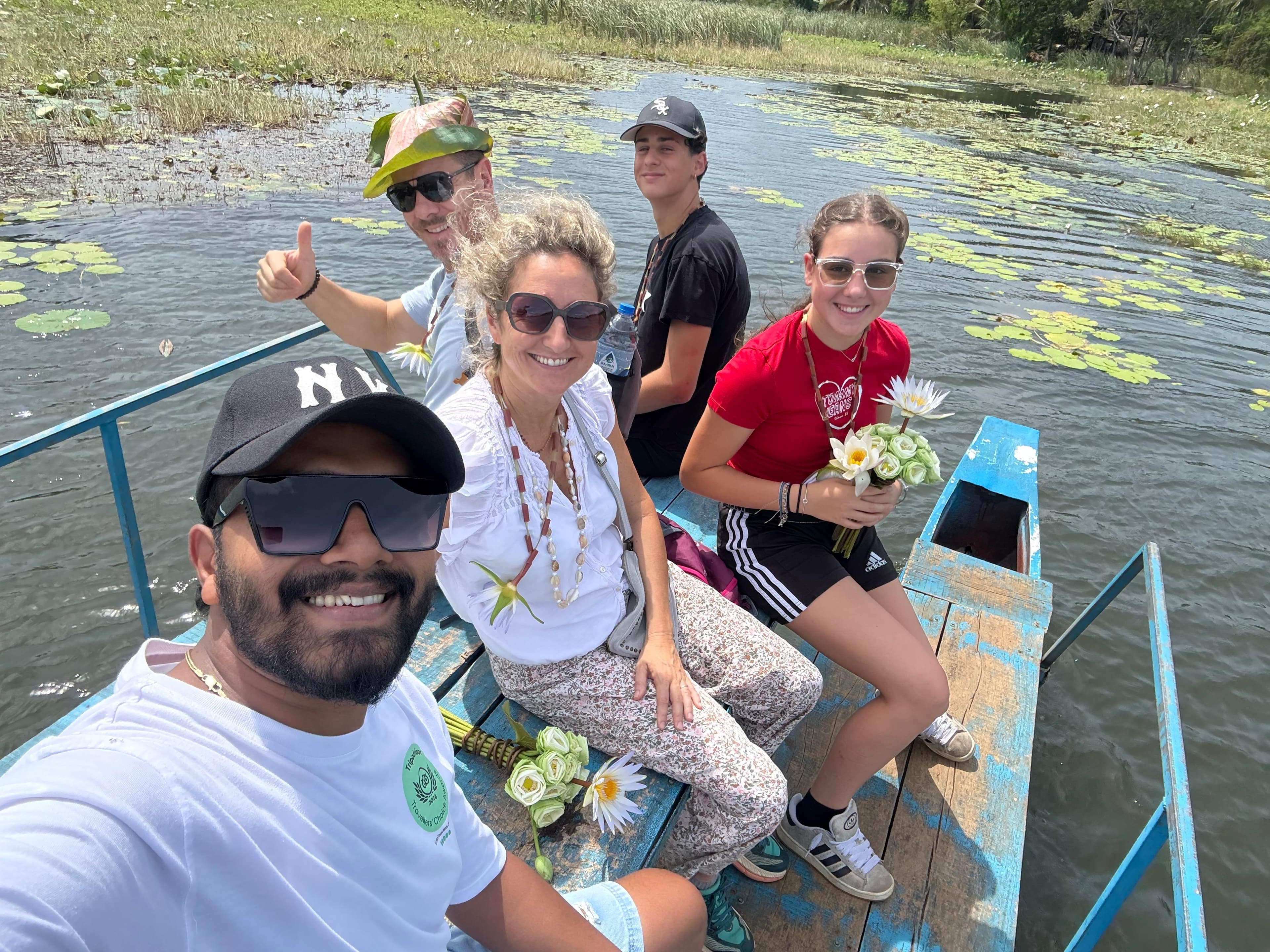 Guide and family on a boat in the lotus lagoon