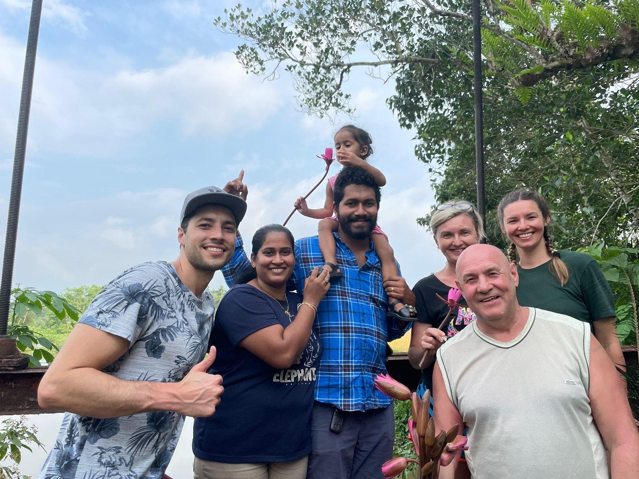 Guests with a local family at the lotus lagoon