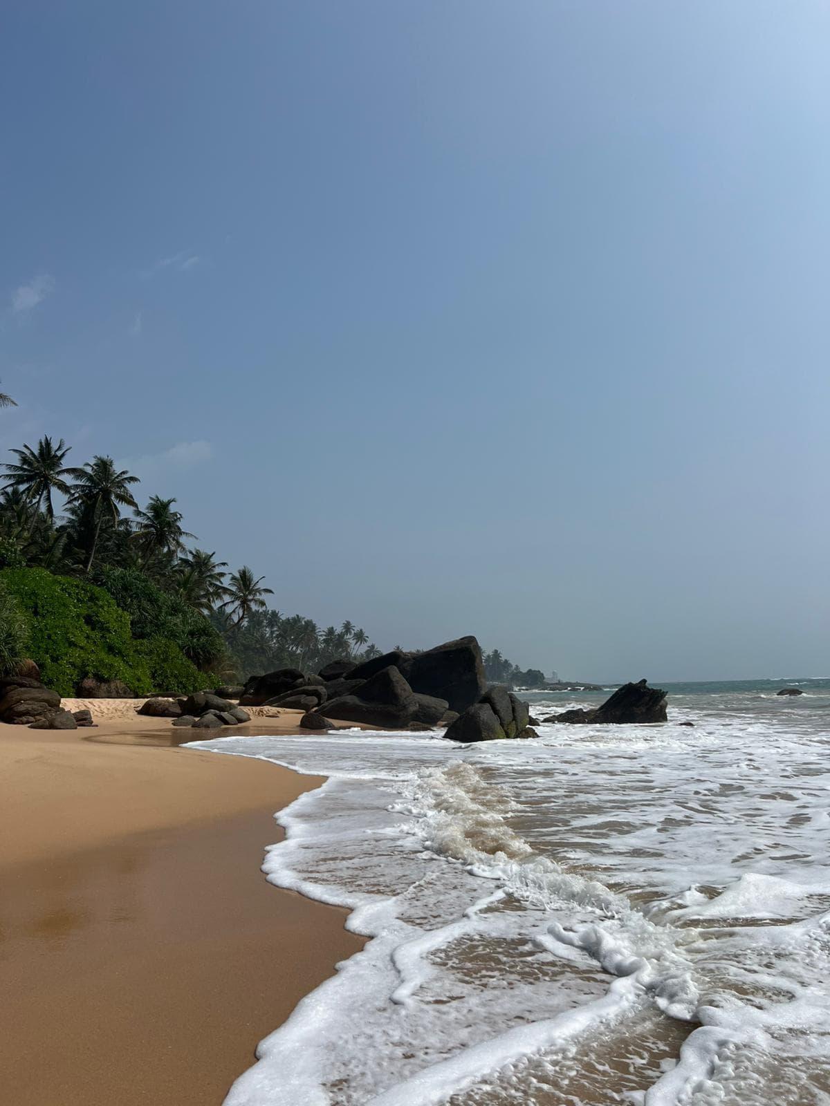 Empty golden sand beach with rolling waves