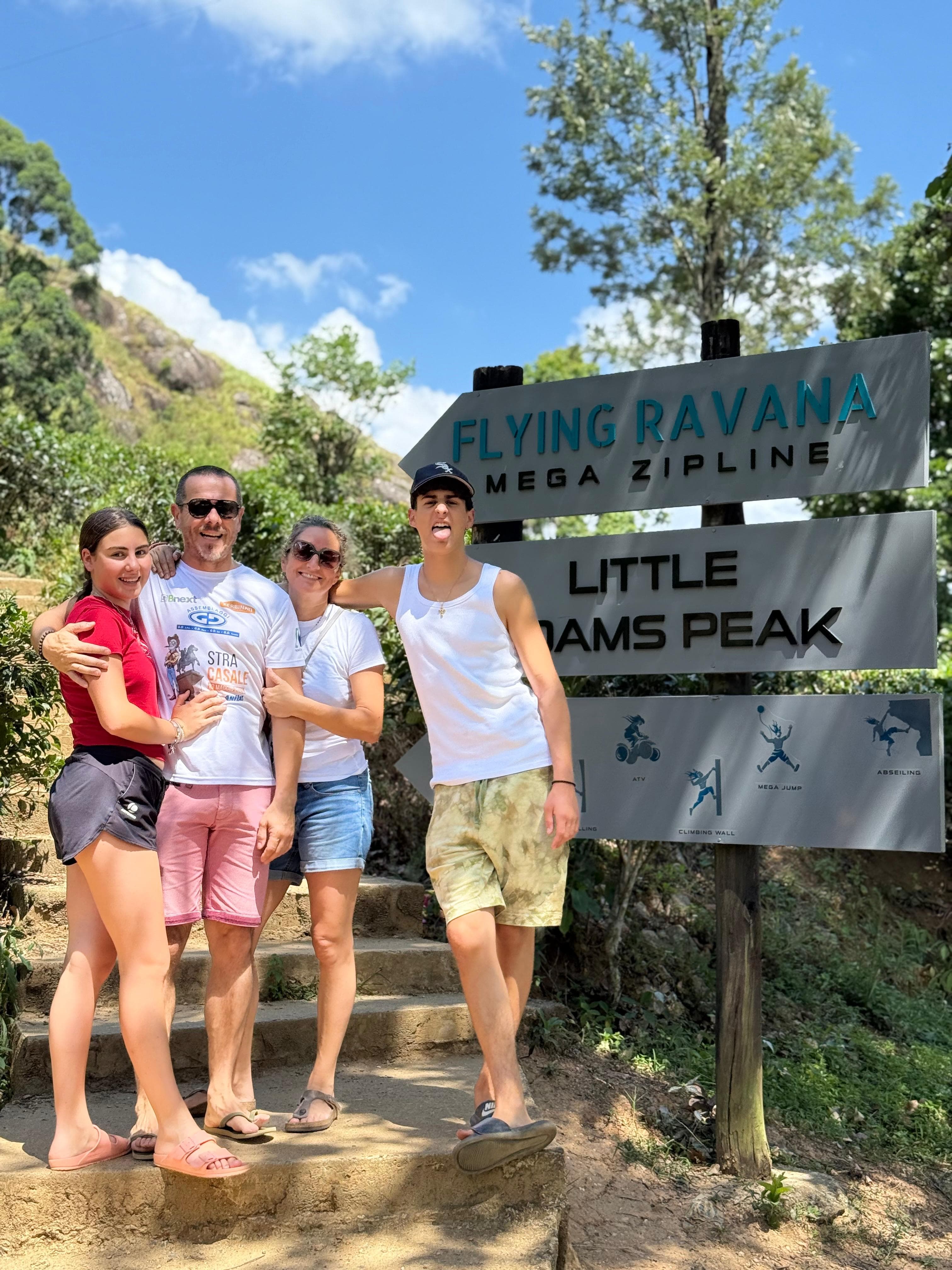 Family at the Ravana zipline and Adam's Peak sign
