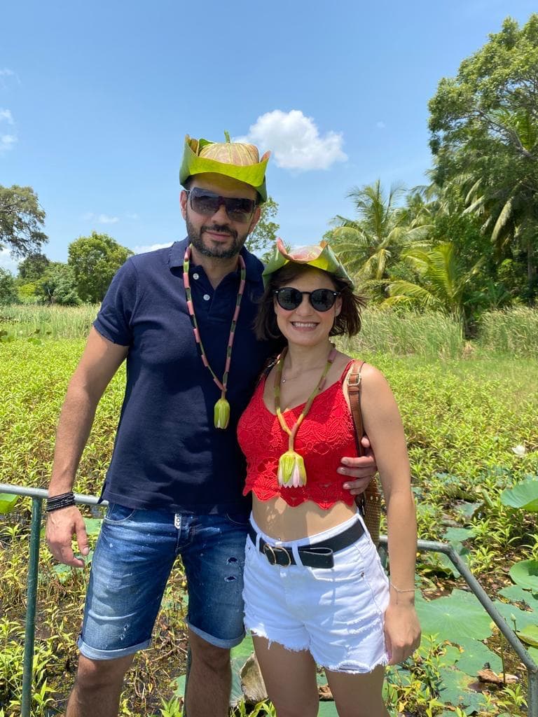 Couple wearing lotus leaf hats in the wetland