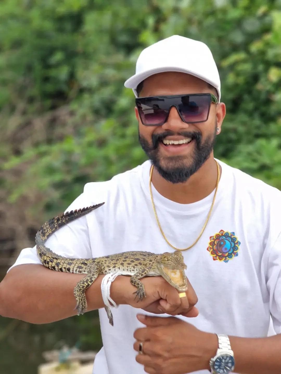 Guide holding a small crocodile