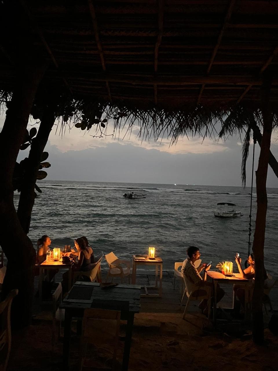 Beachfront restaurant tables at dusk