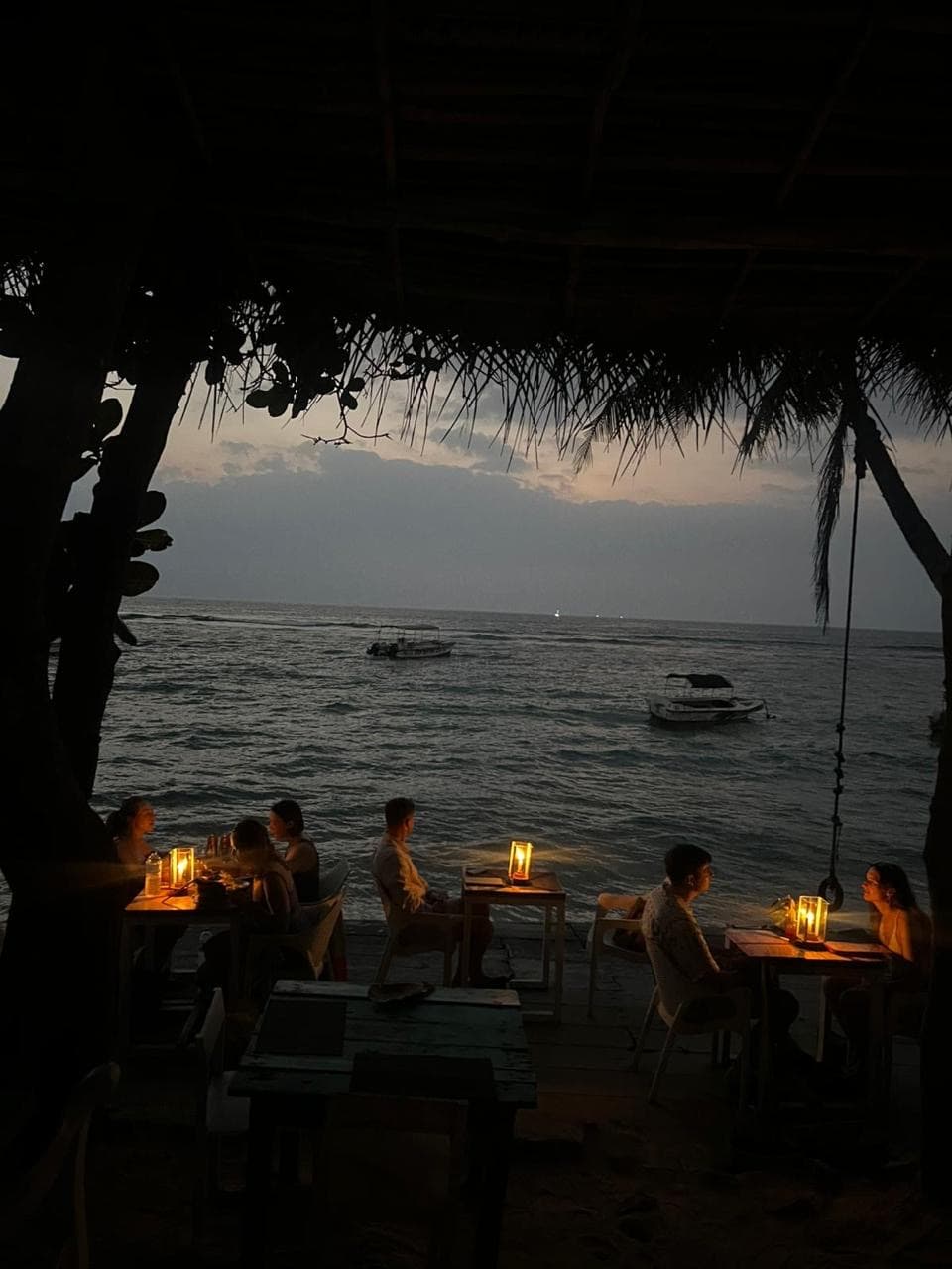 Beachfront restaurant tables at dusk