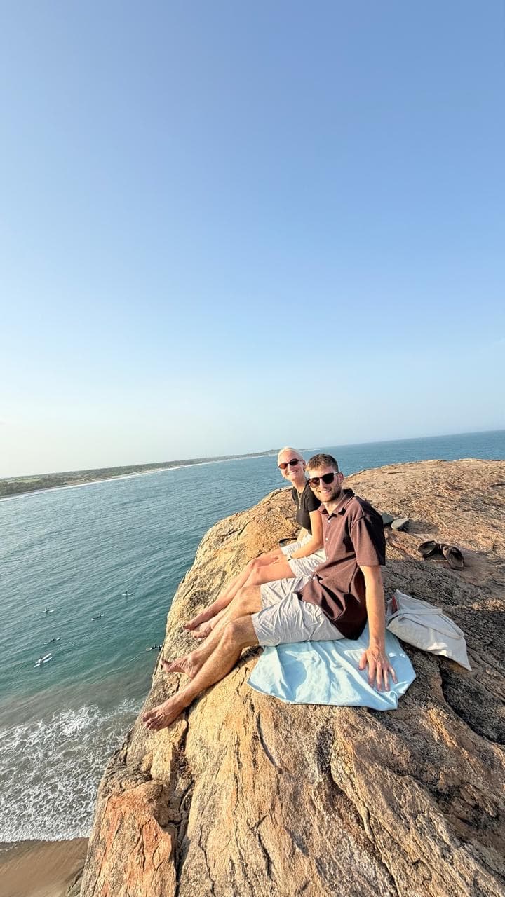 Couple on a rocky cliff with an ocean view