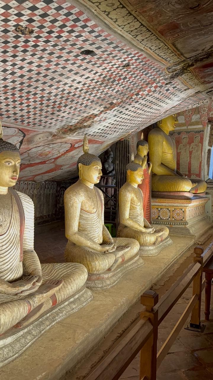 Row of seated Buddha statues at Dambulla cave temple