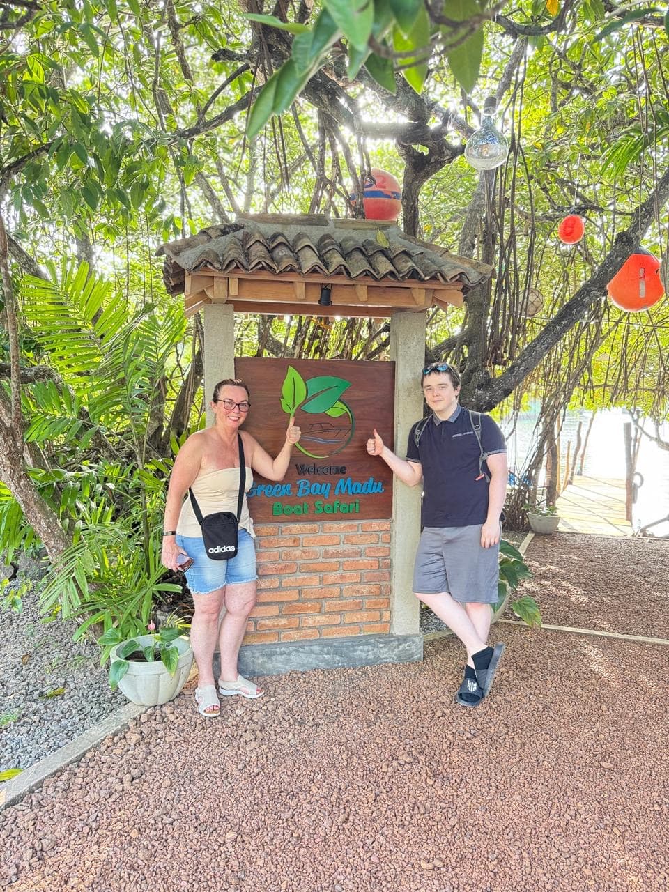 Guests at the Madu River boat safari sign