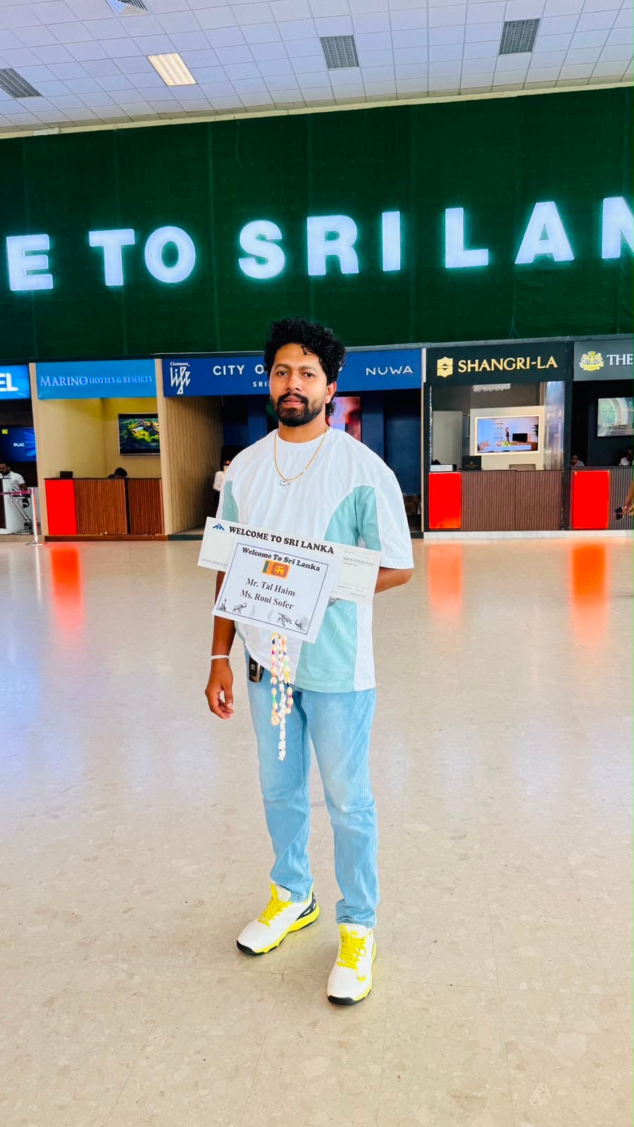 Guide holding a welcome sign for arriving guests at the airport
