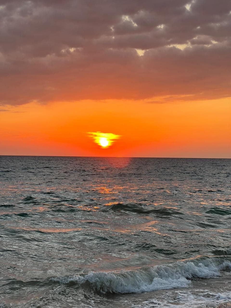 Ocean sunset with an orange sky