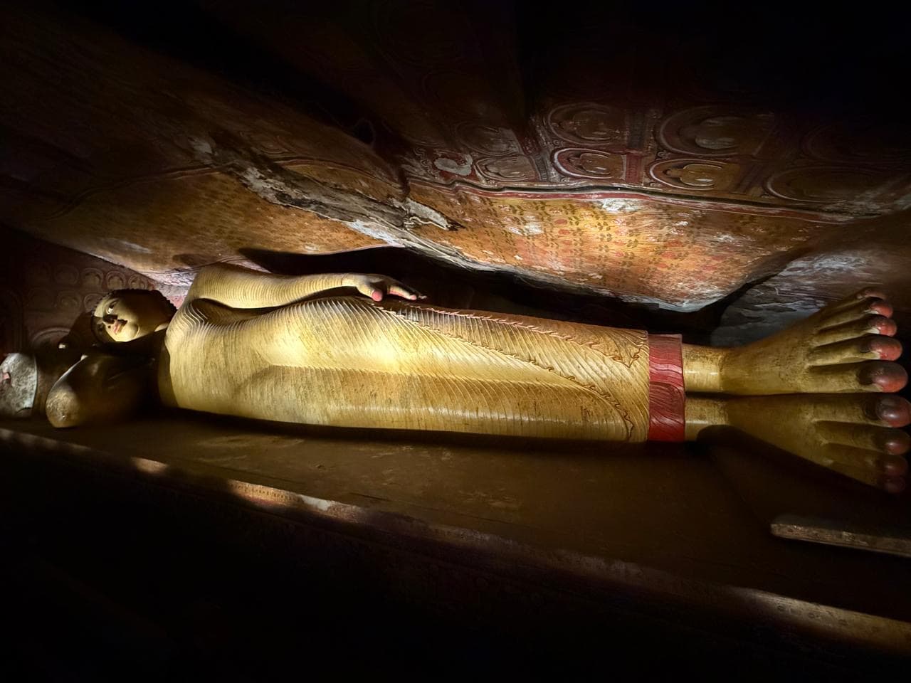 Reclining Buddha statue in a cave temple