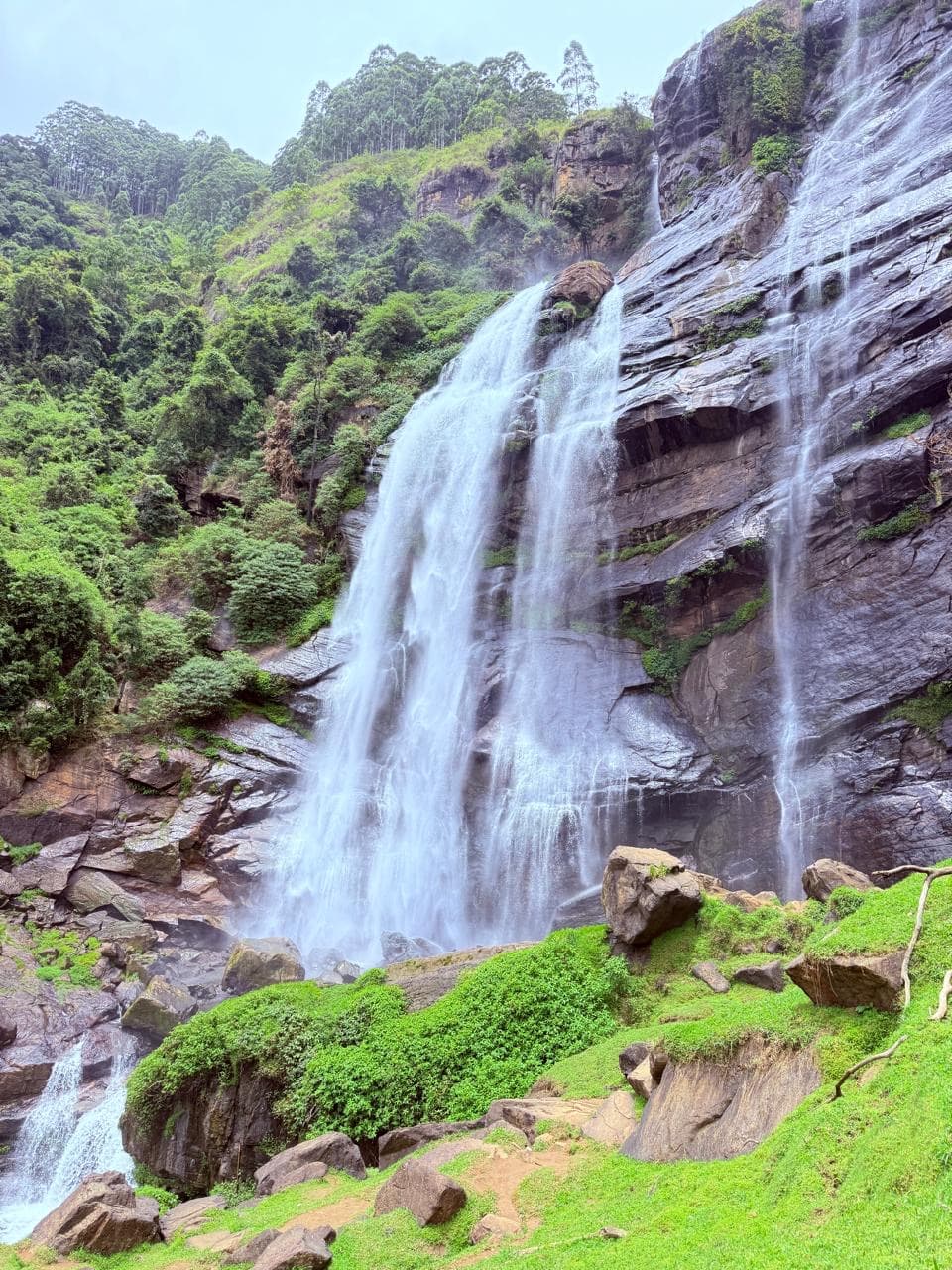 Tall cascading waterfall down a cliff face
