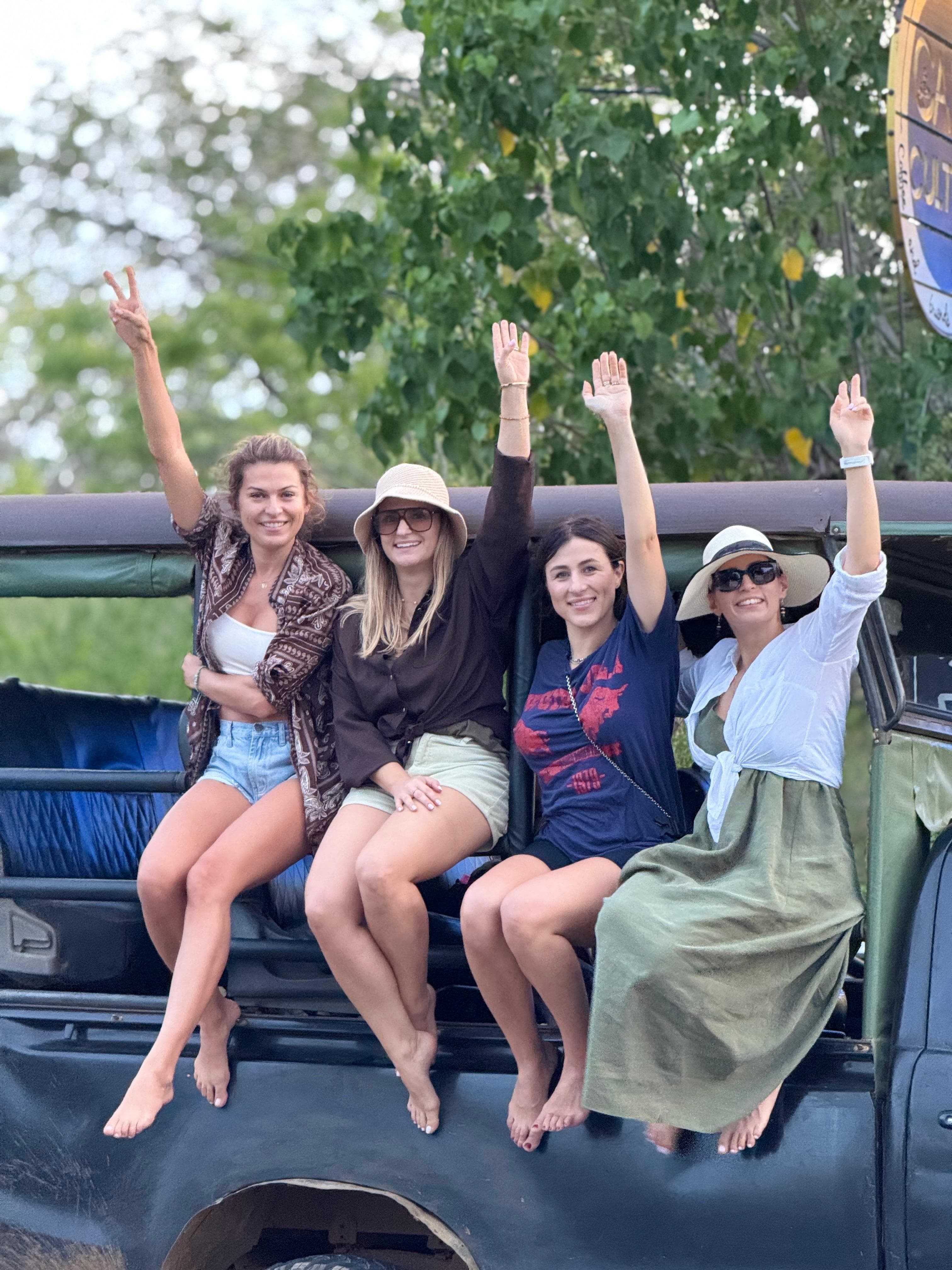 Guests waving from the roof of a safari jeep